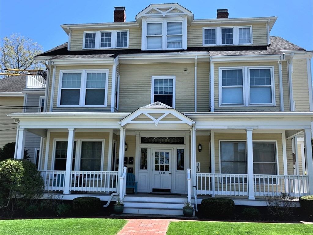 110 Maple Place, Unit 7 Dedham, MA 02026 - Photo 1 of 17 front view of a house with a yard