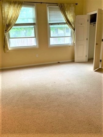 110 Maple Place, Unit 7 Dedham, MA 02026 - Photo 13 of 17 an empty room with a window