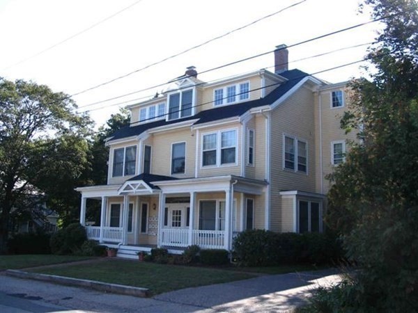110 Maple Place, Unit 7 Dedham, MA 02026 - Photo 2 of 17 a front view of a house with a garden and plants