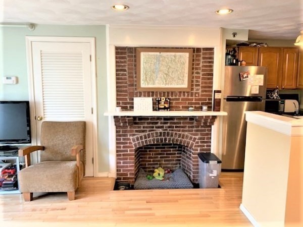 110 Maple Place, Unit 7 Dedham, MA 02026 - Photo 6 of 17 a living room with furniture a flat screen tv and a fireplace