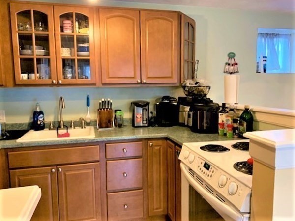 110 Maple Place, Unit 7 Dedham, MA 02026 - Photo 9 of 17 a kitchen with a stove a sink and a refrigerator