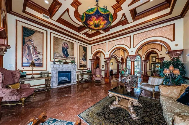 a living room with fireplace furniture and wooden floor