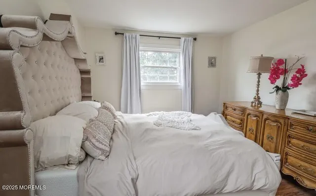 a bedroom with a bed and a chandelier