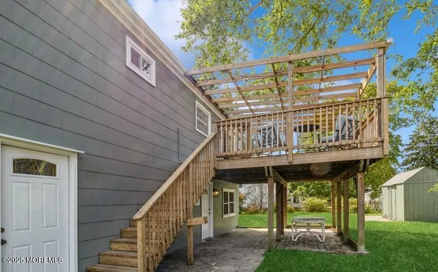 a front view of a house with a wooden deck