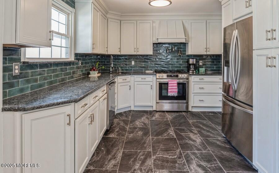24 Layton Avenue Pine Beach, NJ 08741 - Photo 8 of 25 a kitchen with stainless steel appliances granite countertop a stove a sink and a refrigerator