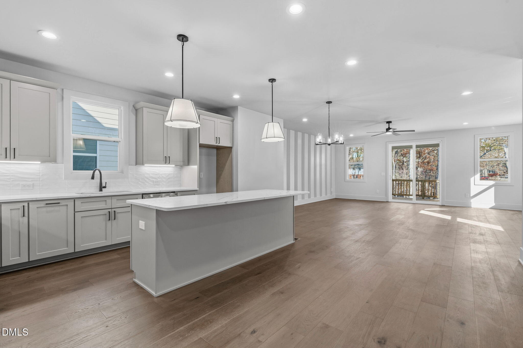 635 Conover Road, Unit B Durham, NC 27703 - Photo 11 of 48 a open kitchen with stainless steel appliances granite countertop a refrigerator a sink dishwasher a oven and a dining table with wooden floor