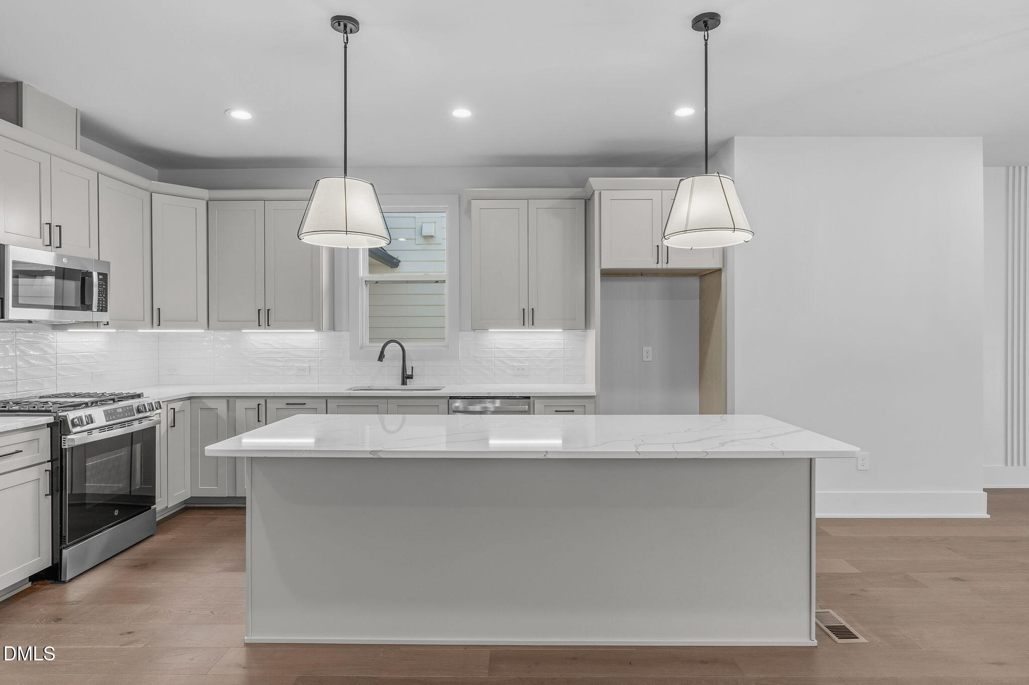 635 Conover Road, Unit B Durham, NC 27703 - Photo 12 of 48 a large kitchen with granite countertop a sink a stove and a refrigerator