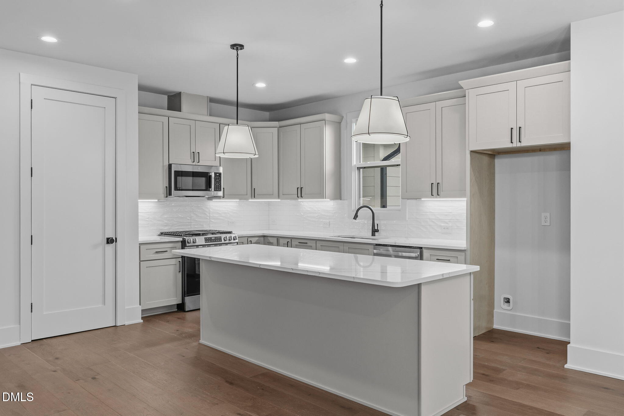 635 Conover Road, Unit B Durham, NC 27703 - Photo 13 of 48 a kitchen with stainless steel appliances granite countertop a sink stove and refrigerator