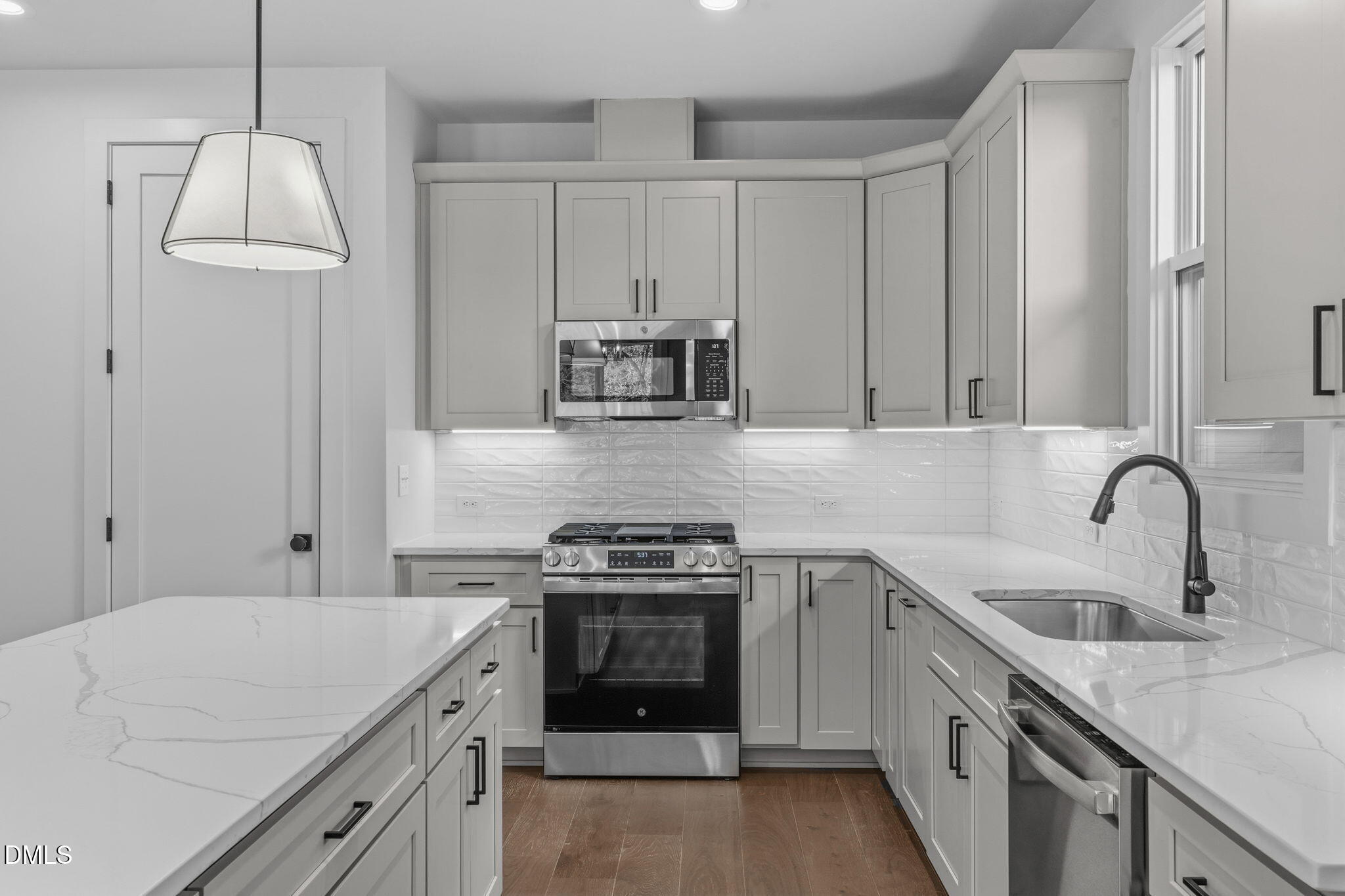 635 Conover Road, Unit B Durham, NC 27703 - Photo 14 of 48 a kitchen with granite countertop a sink a stove and refrigerator