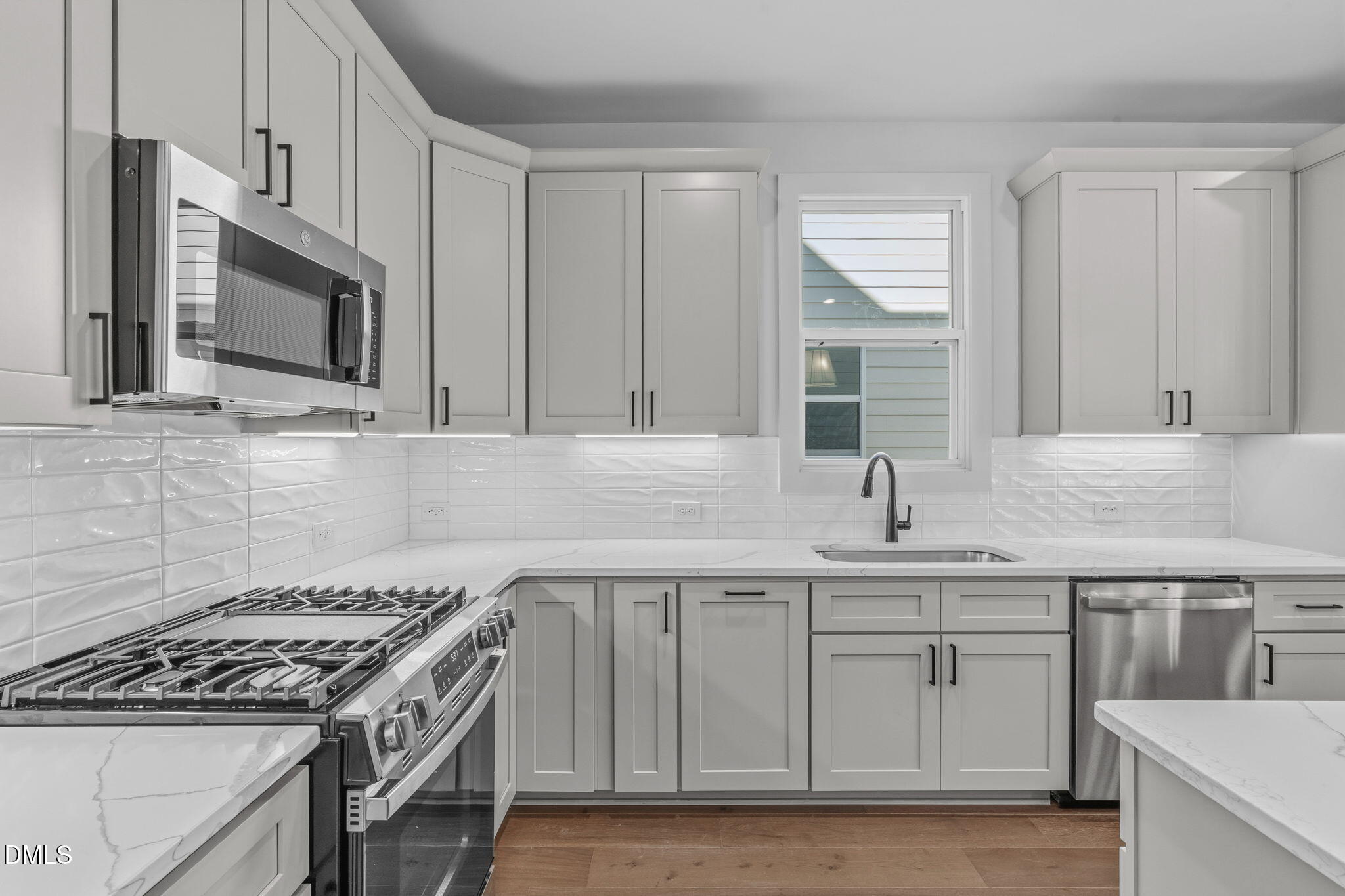 635 Conover Road, Unit B Durham, NC 27703 - Photo 15 of 48 a kitchen with stainless steel appliances granite countertop a sink stove and microwave