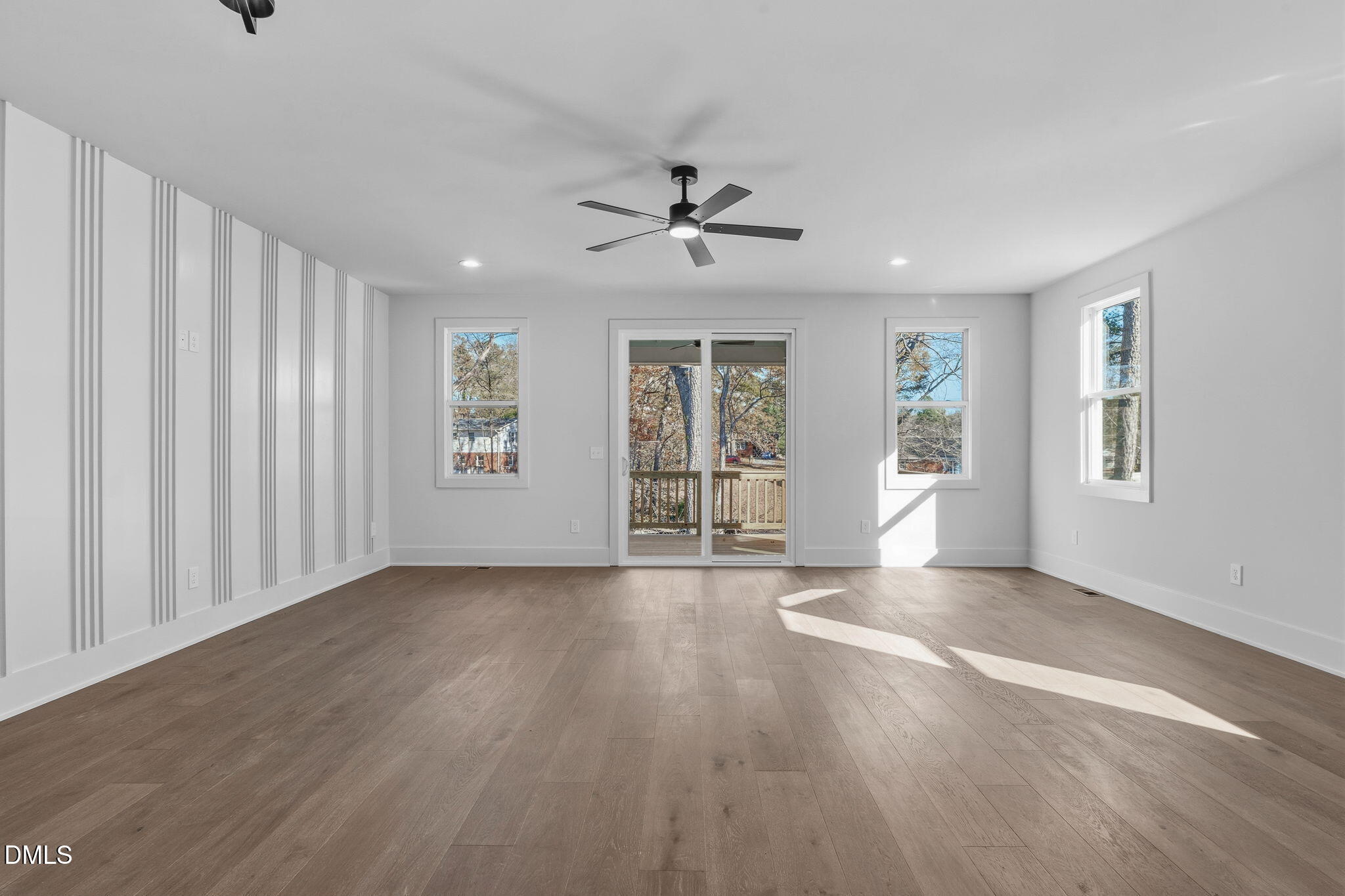 635 Conover Road, Unit B Durham, NC 27703 - Photo 18 of 48 an empty room with wooden floor chandelier fan and windows
