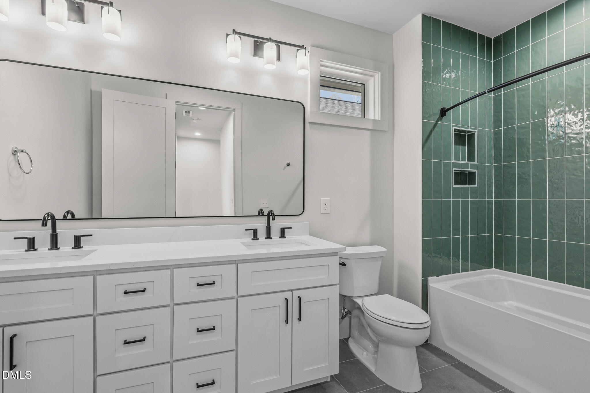 635 Conover Road, Unit B Durham, NC 27703 - Photo 37 of 48 a bathroom with a double vanity sink toilet mirror and shower