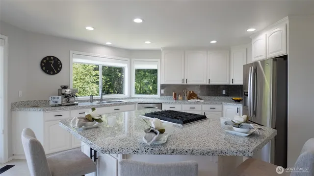 a kitchen with a sink a stove a refrigerator and cabinets
