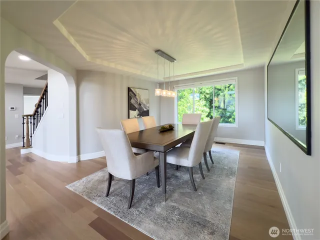 a dining room with furniture and a floor to ceiling window