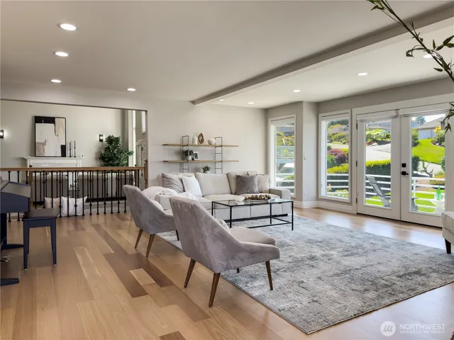 a living room with furniture and a floor to ceiling window