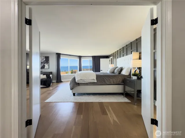 a bedroom with furniture and a wooden floor