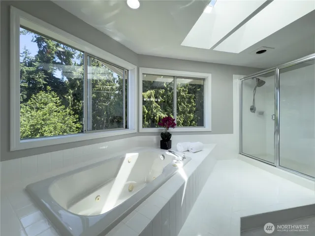 a bath tub sitting in a bathroom next to a window