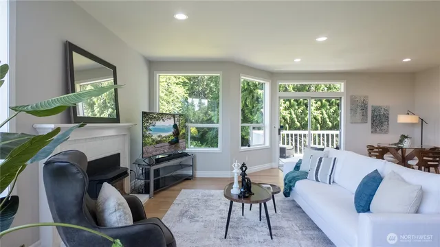 a living room with fireplace furniture and a large window