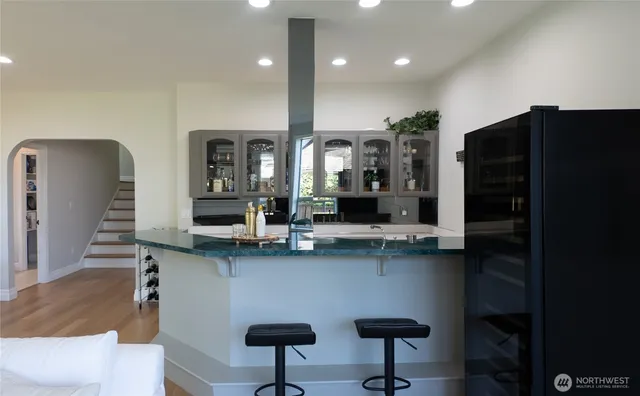 a kitchen with stainless steel appliances granite countertop a refrigerator and a sink