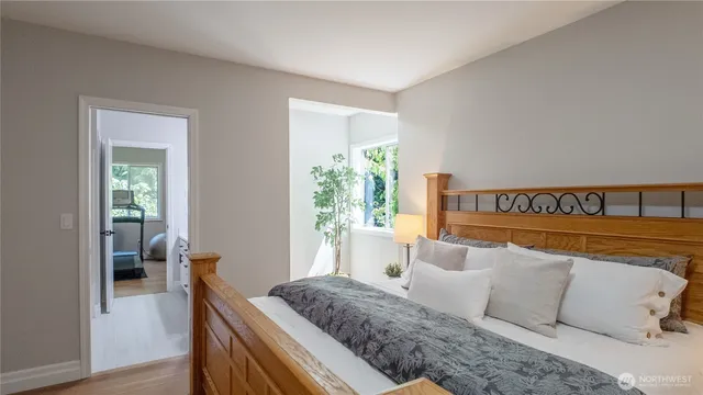 a bedroom with a bed and a window