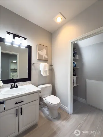 a bathroom with a sink a toilet a light fixture and mirror