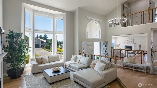 a living room with furniture ceiling fan and a window