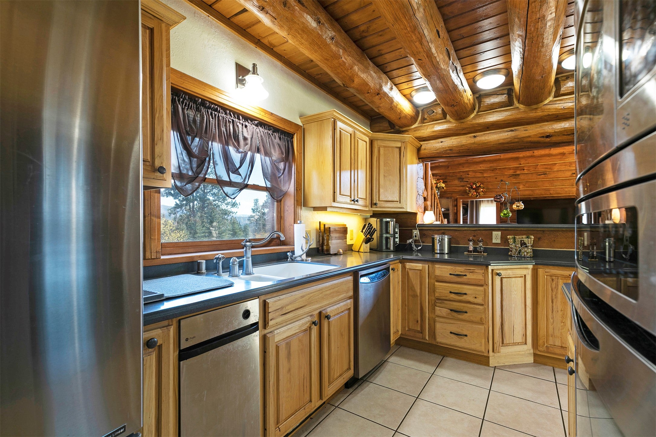 203 Hart Bench Road Darby, MT 59829 - Photo 11 of 56 A generous kitchen window fills the space with natural light, enhancing the inviting warmth and Montana-inspired design.