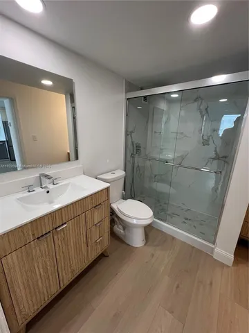 a bathroom with a double vanity sink toilet and shower