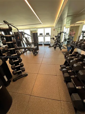 a room with gym equipment and a large window