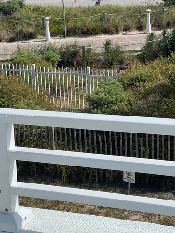 a view of a garden with wooden fence