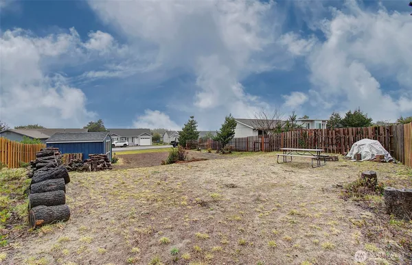 a backyard of a house with table and chairs