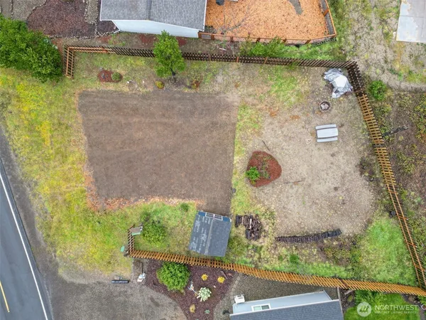 an aerial view of a house with a yard and a large tree