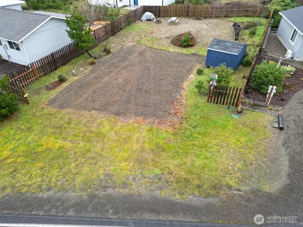 an aerial view of a house with a yard and lake view