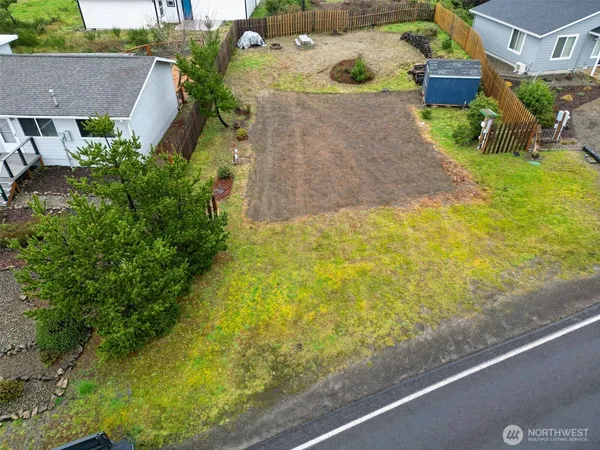 an aerial view of residential house with pool and yard
