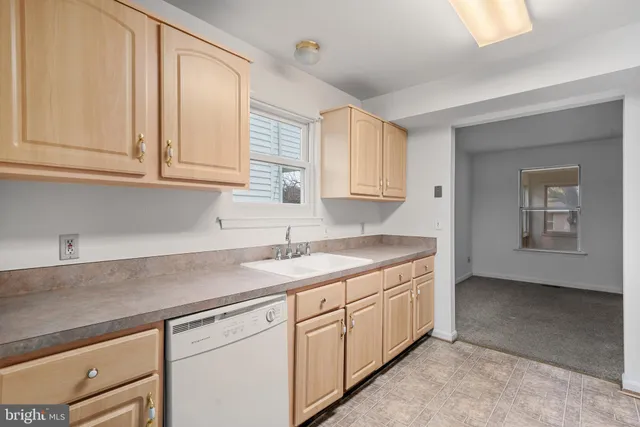 a kitchen with granite countertop white cabinets and sink