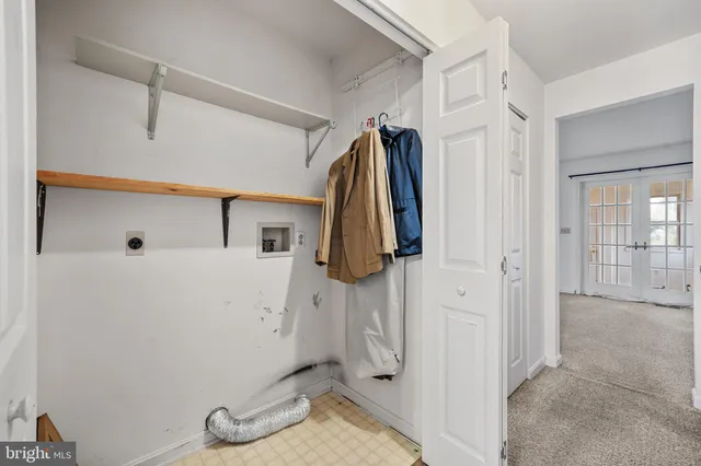 a view of walk in closet with clothes