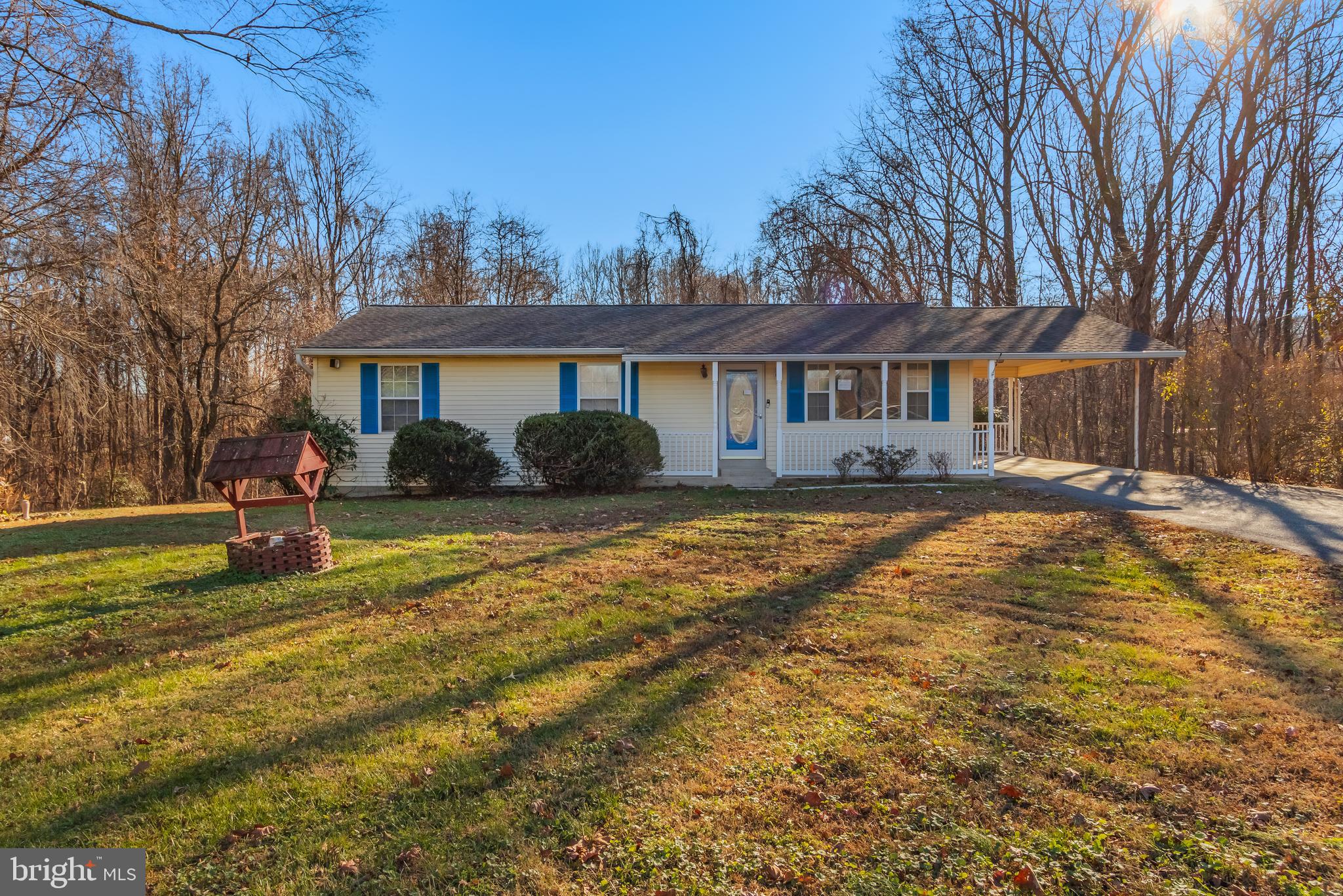 a front view of house with yard and trees around