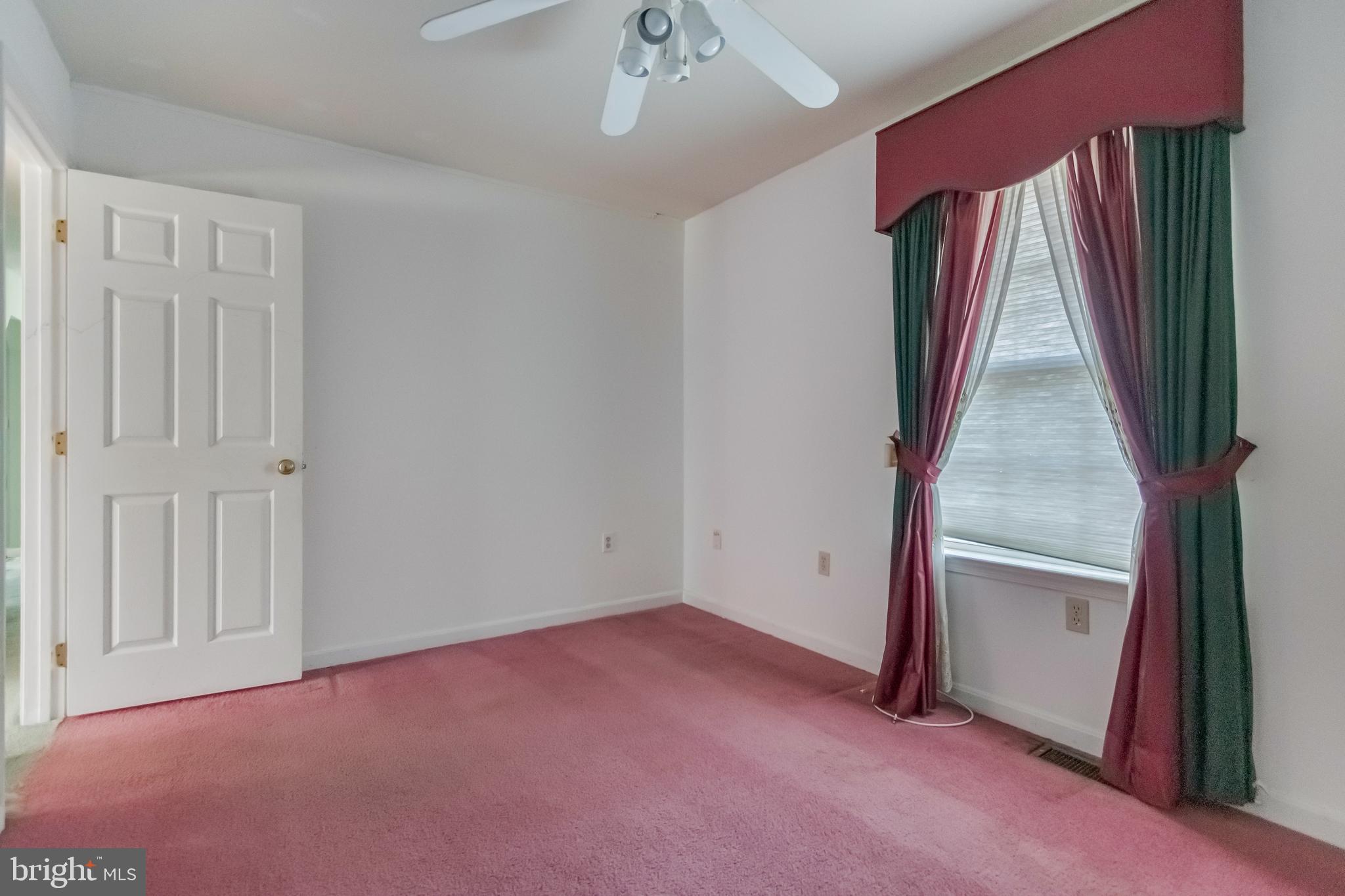 1104 Saffron Way Owings, MD 20736 - Photo 23 of 26 an empty room with a windows and stairs