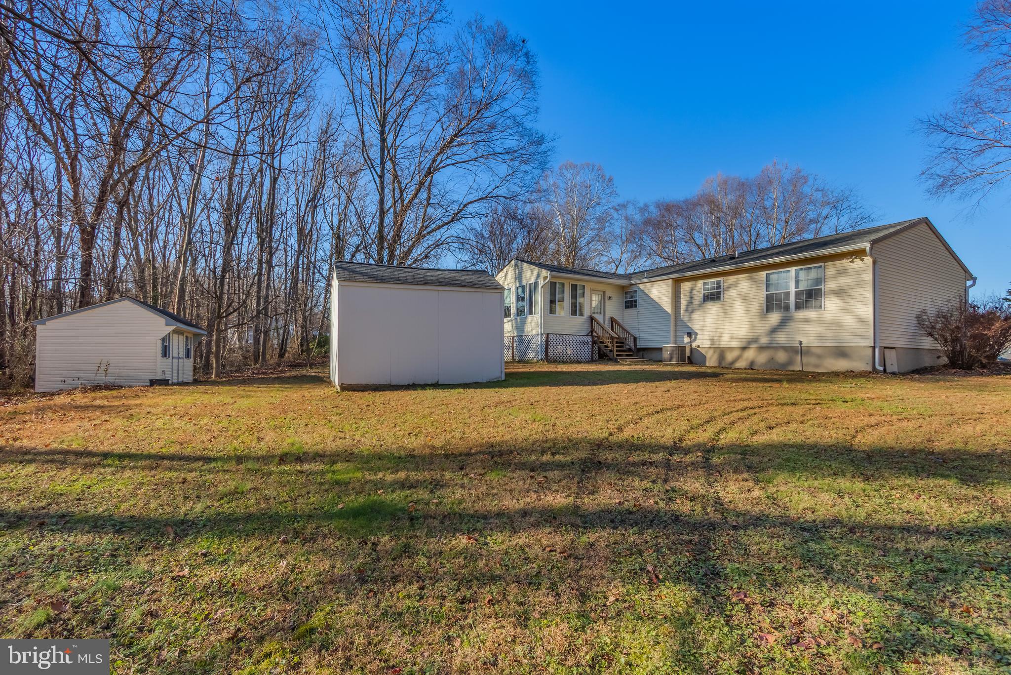 1104 Saffron Way Owings, MD 20736 - Photo 25 of 26 a front view of house with yard and trees