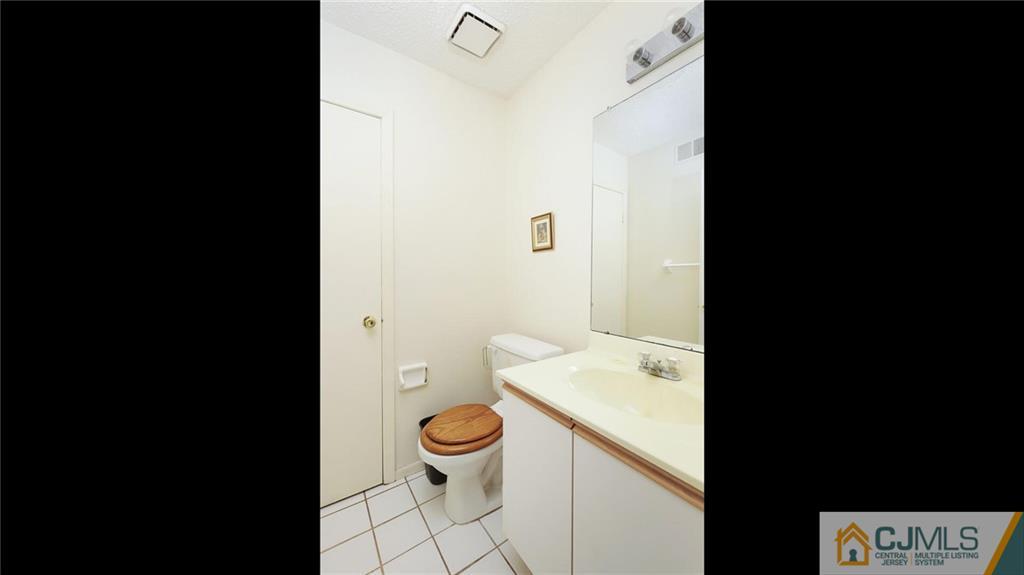 169 Nebula Road Piscataway, NJ 08854 - Photo 21 of 31 a bathroom with a toilet a sink and a large mirror