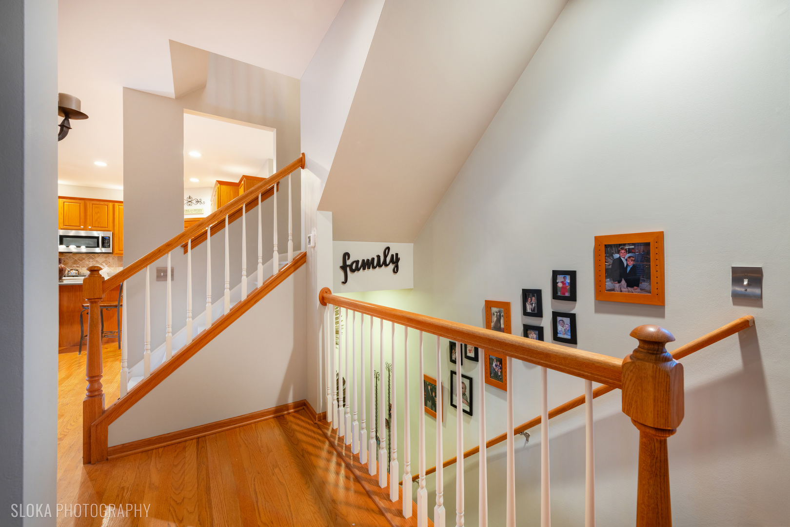 1123 Village Road Crystal Lake, IL 60014 - Photo 16 of 46 a view of staircase with lots of frames on wall and wooden floor