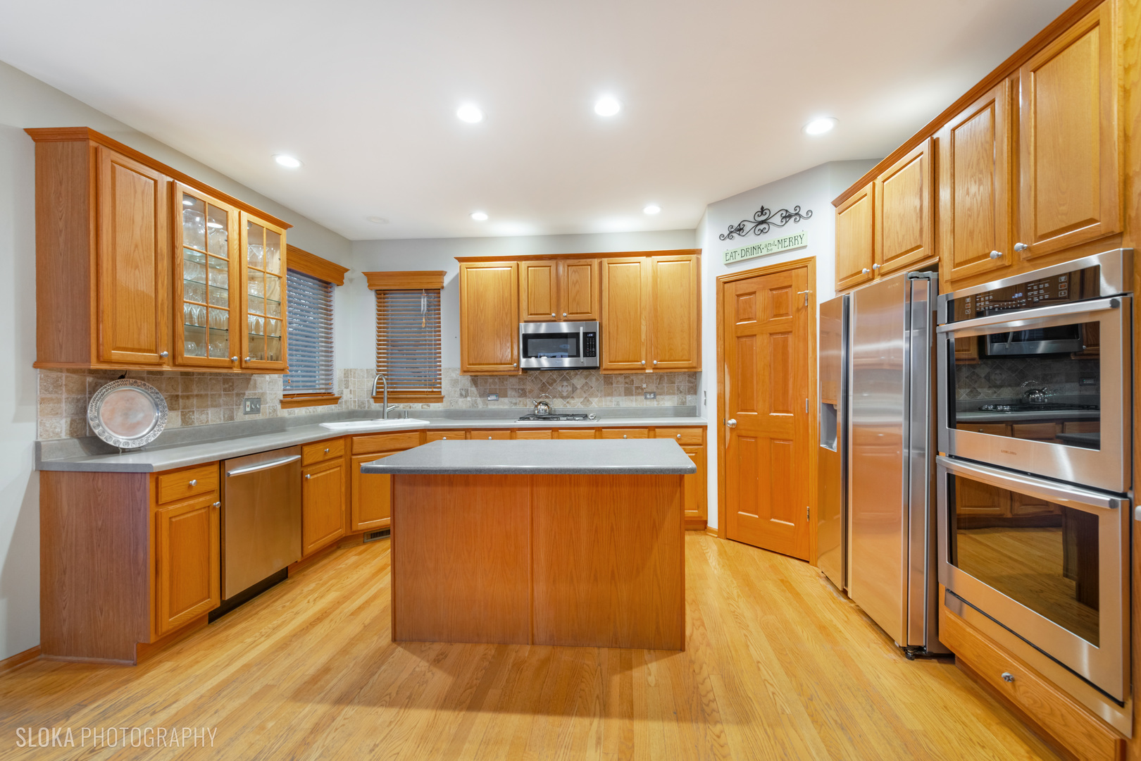1123 Village Road Crystal Lake, IL 60014 - Photo 5 of 46 a large kitchen with stainless steel appliances granite countertop a stove a sink and a refrigerator