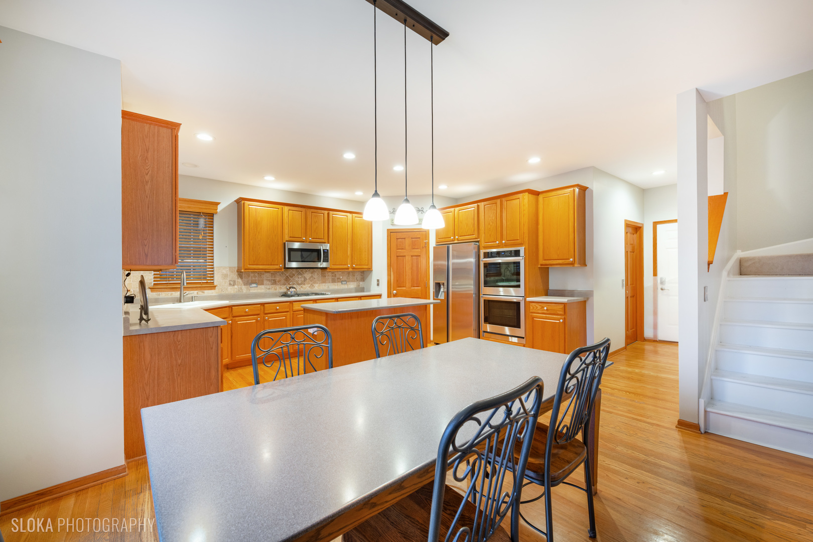 1123 Village Road Crystal Lake, IL 60014 - Photo 6 of 46 a view of a dining room with furniture and wooden floor