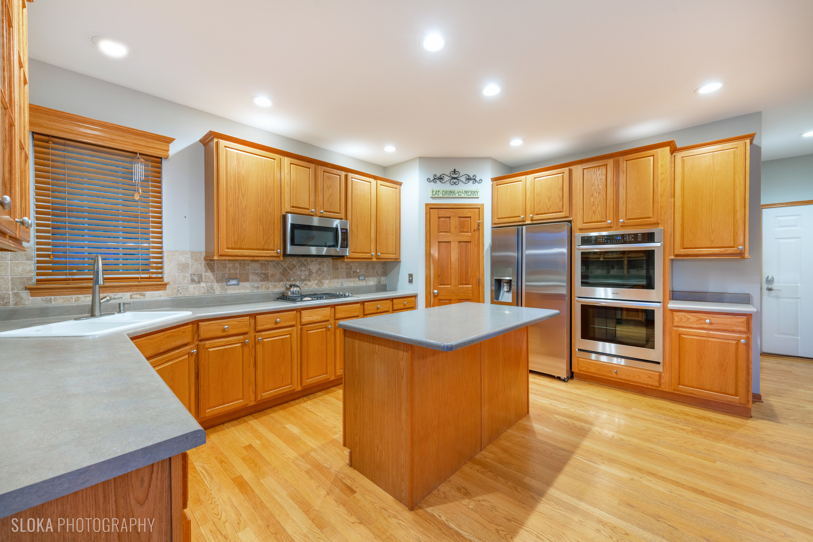 1123 Village Road Crystal Lake, IL 60014 - Photo 7 of 46 a large kitchen with stainless steel appliances granite countertop a stove a sink and a microwave