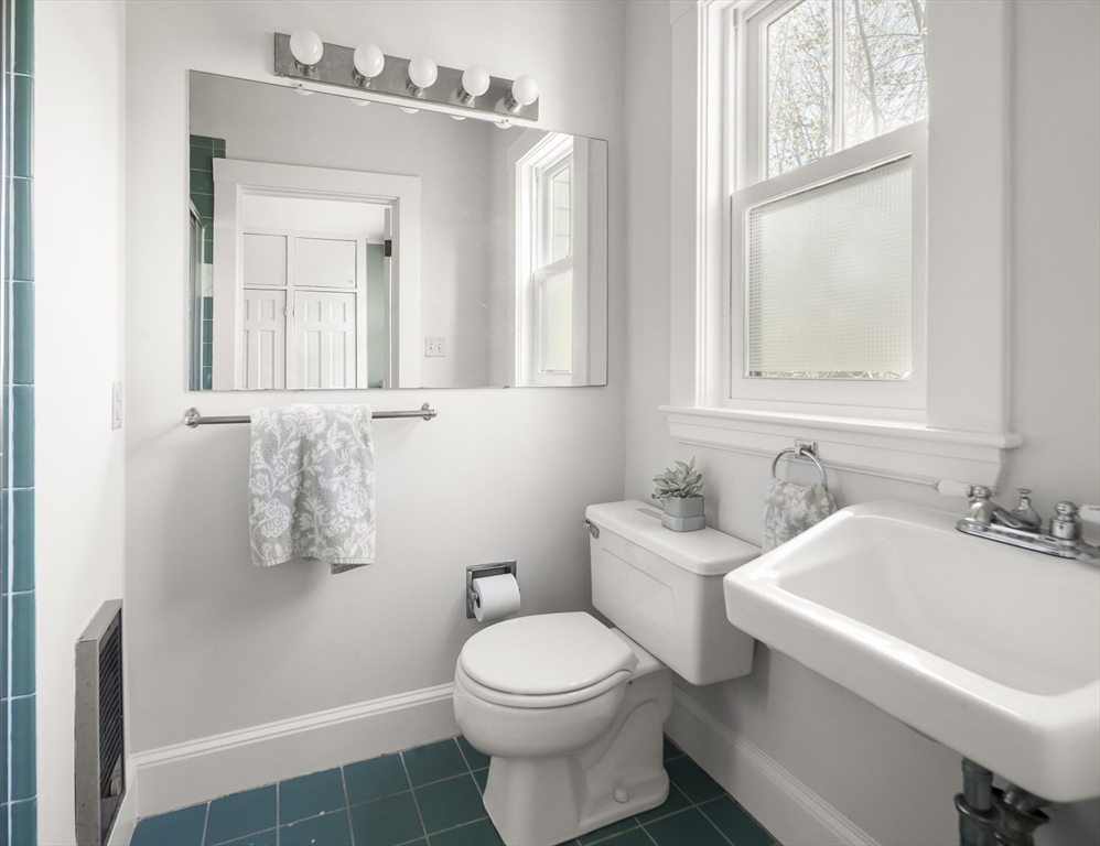40 Eustis Street Cambridge, MA 02140 - Photo 17 of 23 a bathroom with a sink a toilet and a mirror