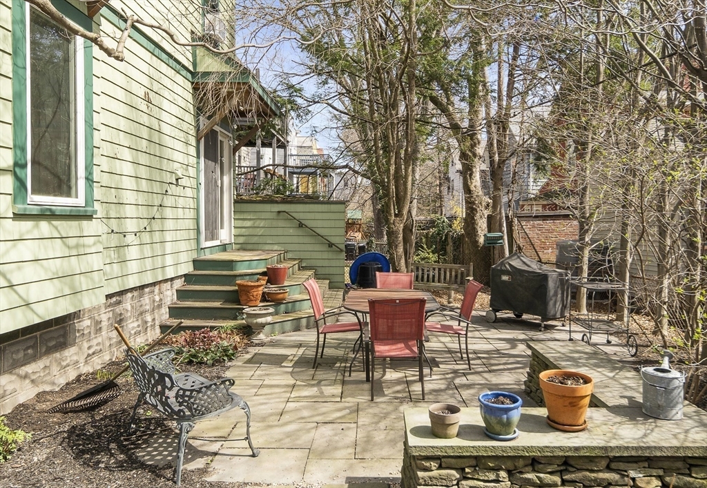 40 Eustis Street Cambridge, MA 02140 - Photo 22 of 23 a view of a patio with table and chairs and potted plants