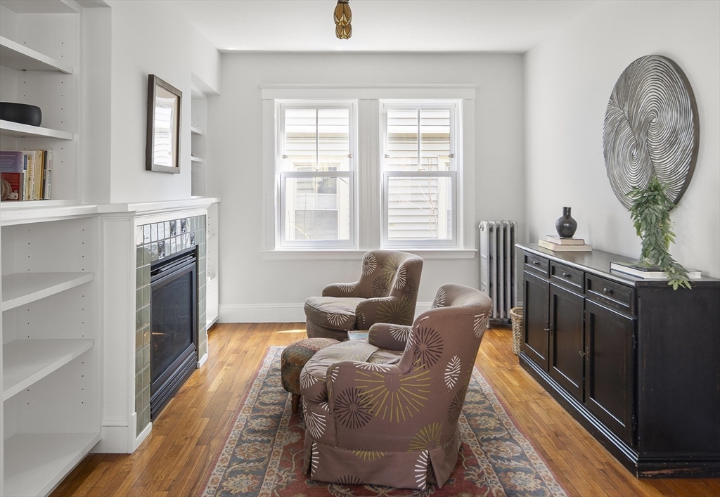 40 Eustis Street Cambridge, MA 02140 - Photo 7 of 23 a living room with furniture a fireplace and a window