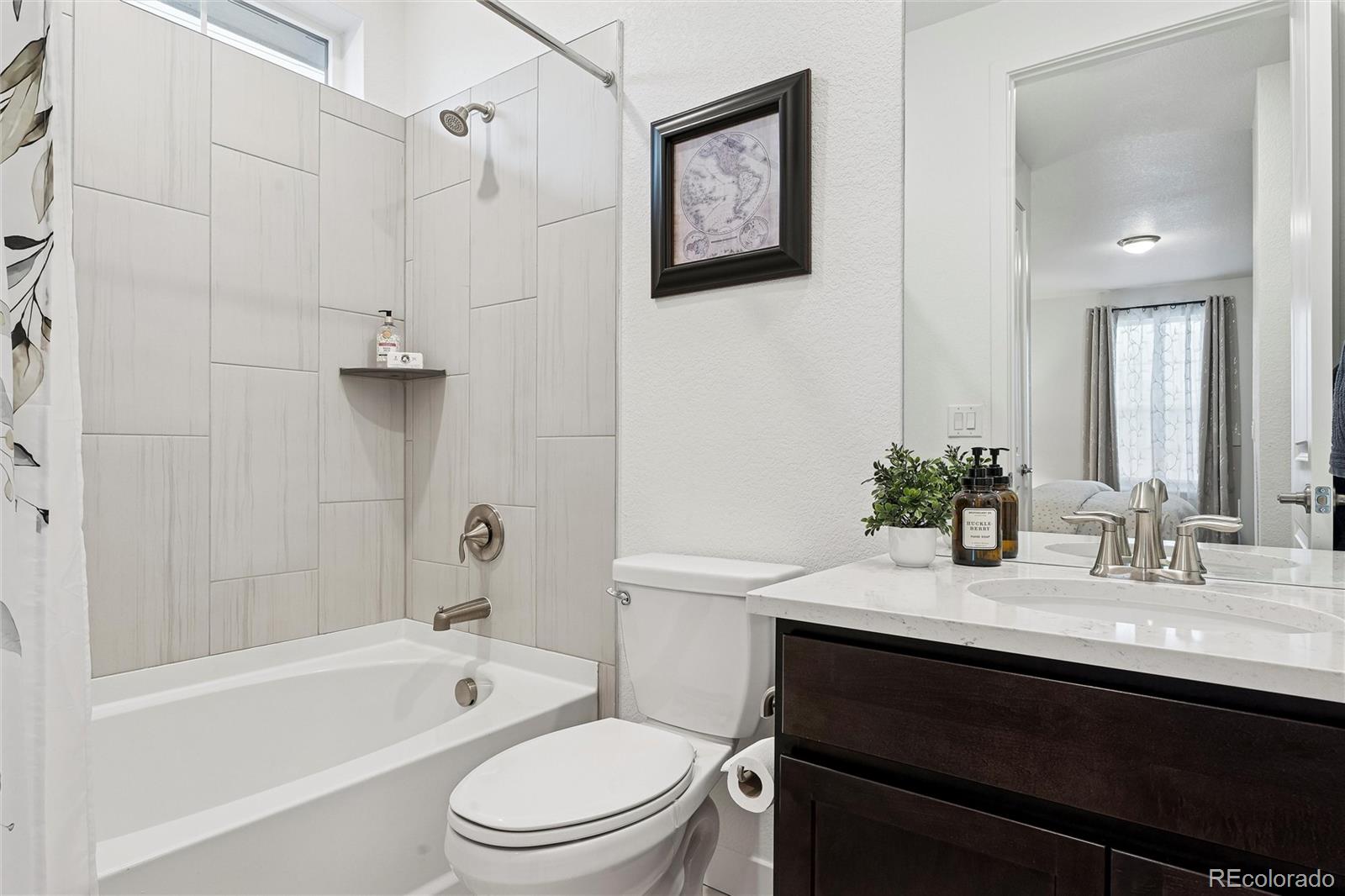 8500 South Riviera Court Aurora, CO 80016 - Photo 22 of 35 a bathroom with a sink a toilet and shower