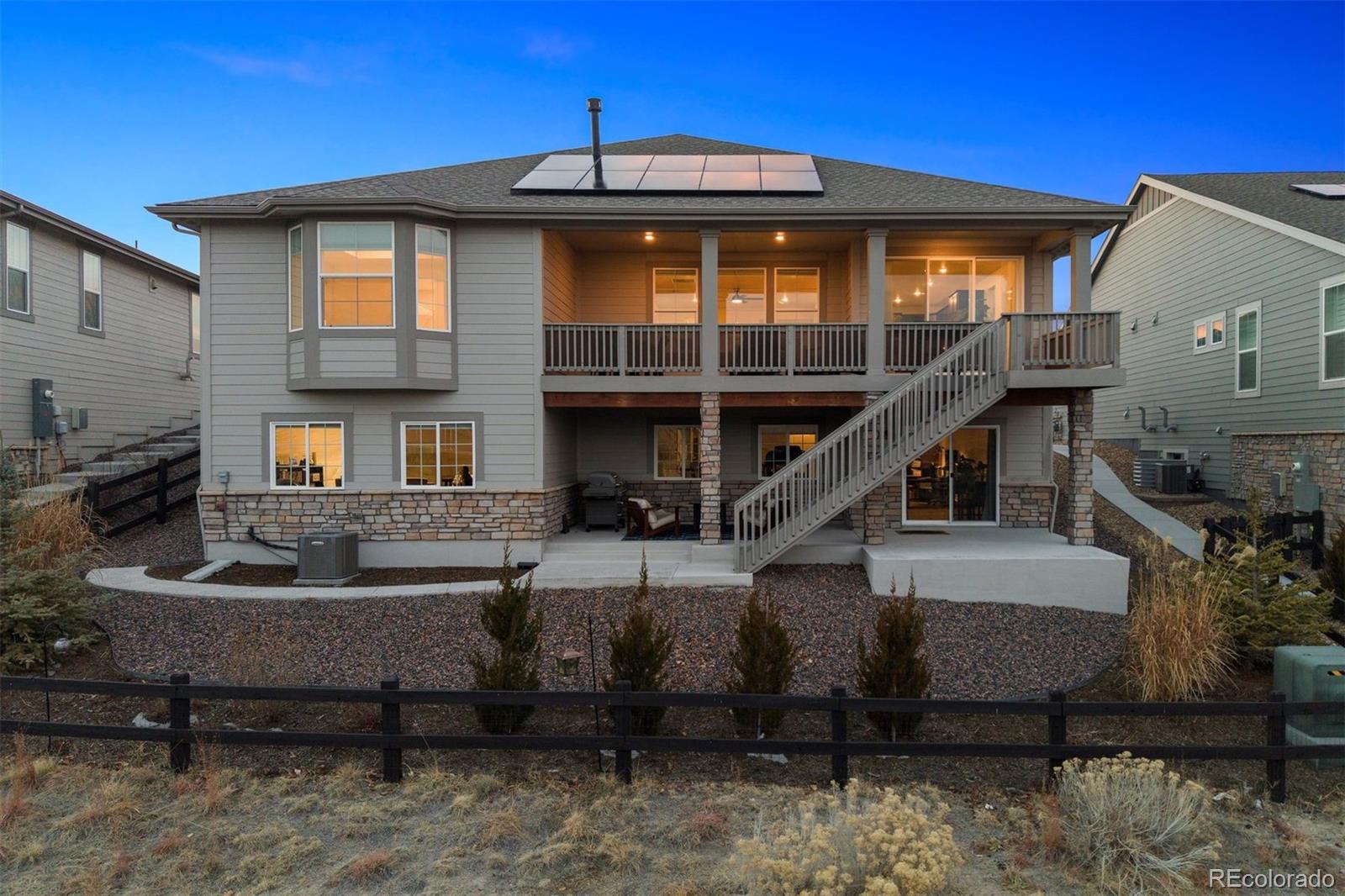 8500 South Riviera Court Aurora, CO 80016 - Photo 34 of 35 a front view of a house with balcony and outdoor seating