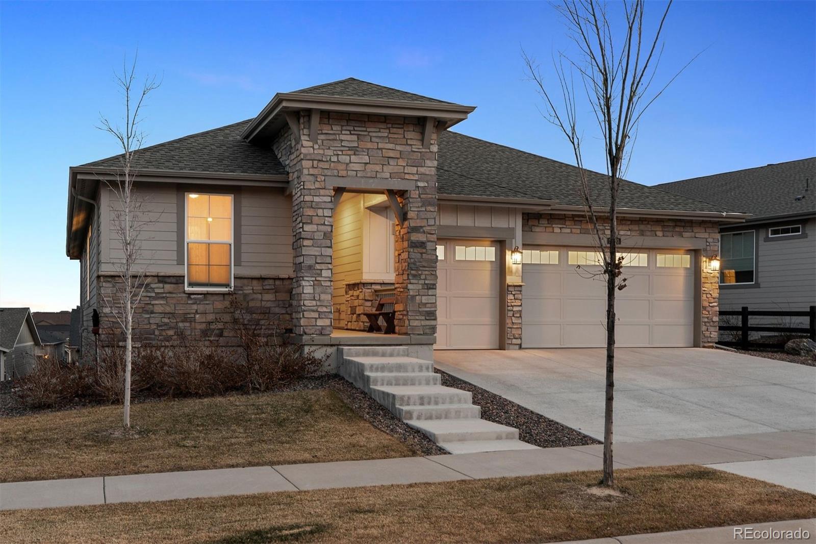 8500 South Riviera Court Aurora, CO 80016 - Photo 4 of 35 a front view of a house with garden